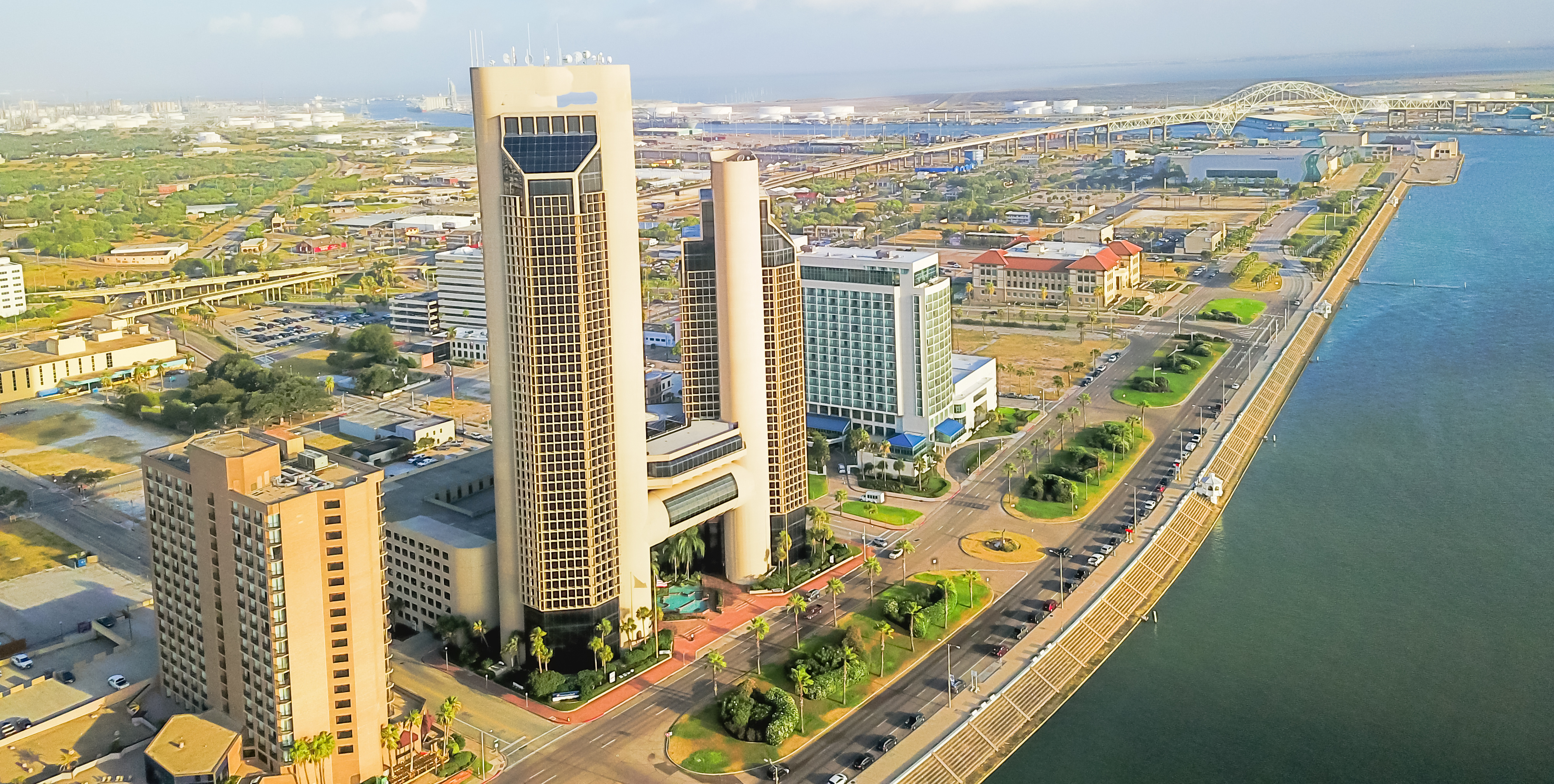 Aerial view of Corpus Christi’s distinctive skyline with the Harbor Bridge in the background.