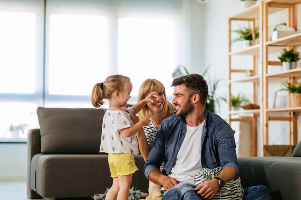 Family enjoying a bright living room enhanced by double pane windows.