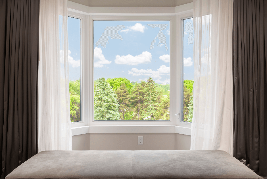 A picturesque bay window with sheer curtains showcasing a scenic view of lush greenery.
Title: Maximizing Views with Bay Windows in Modern Homes