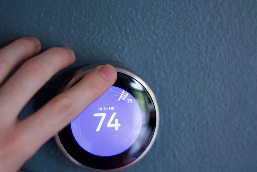 Google Nest Learning Thermostat on a wall, showcasing its sleek design and digital temperature display