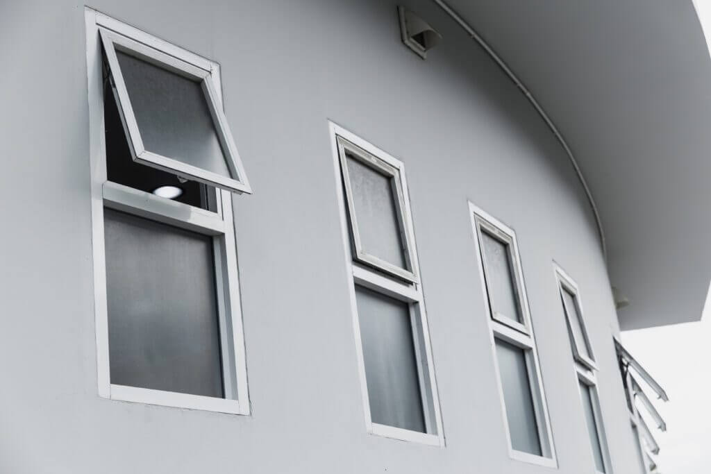 Open awning window on a curved wall, demonstrating easy cleaning access.