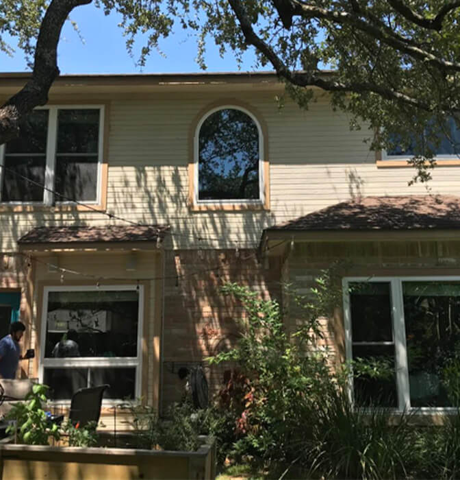 After renovation: Two-story home in San Antonio with new windows and improved landscaping.