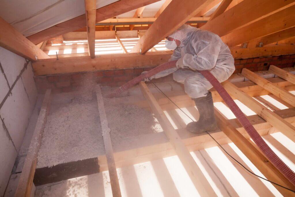 Insulation technician applying cellulose in San Antonio attic