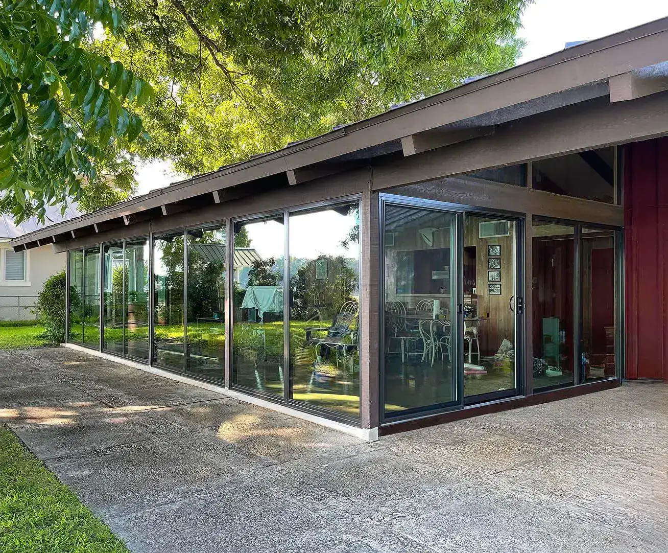 Floor-to-ceiling glass sliding doors enhancing a home's connection to its garden in San Antonio.