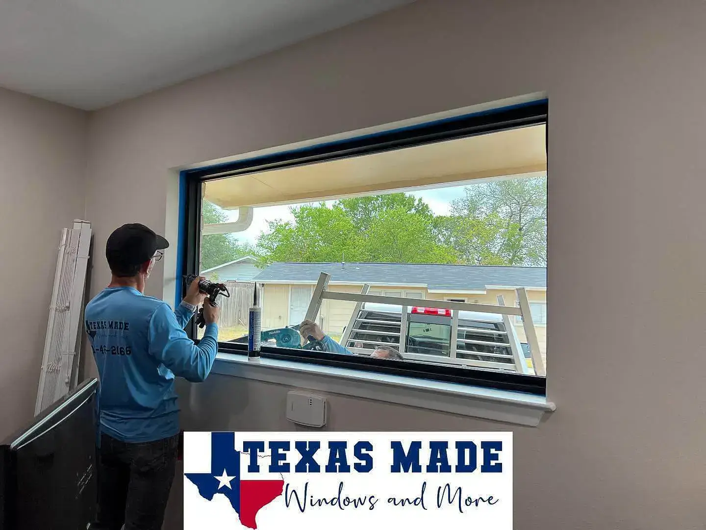 Texas Made Windows and More technician installing a large horizontal window in a San Antonio home.