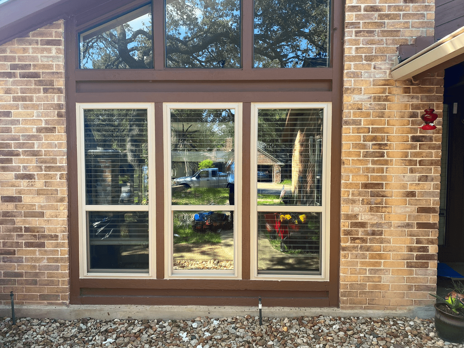 Stylish large window installation in a brick home, enhancing curb appeal in San Antonio, Texas