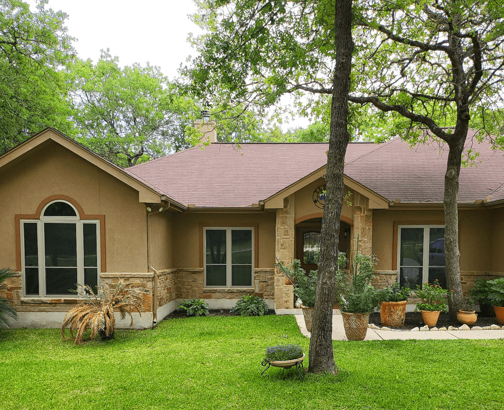 Beautifully landscaped single-story home in the San Antonio region with large windows and a cozy design