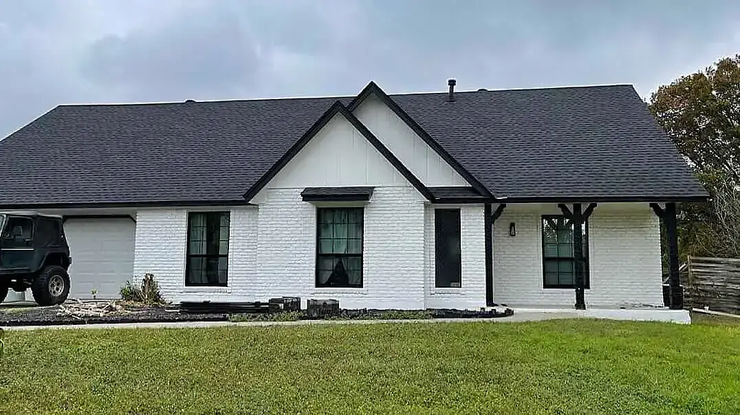 Charming single-story white farmhouse with stylish black windows in Corpus Christi.