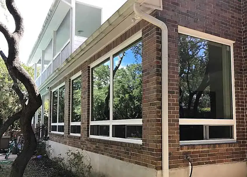 Row of large modern windows installed in a brick building, enhancing natural light in San Antonio, Texas