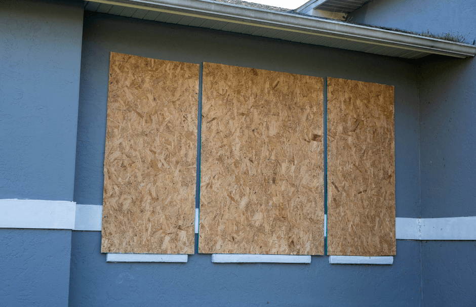 Plywood boards securely mounted on a house window for hurricane window protection