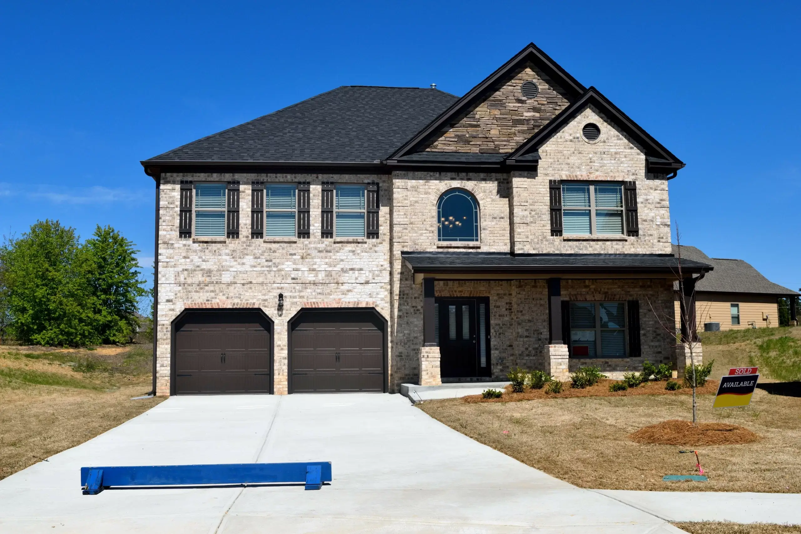 Front view of a modern 3-bedroom house with new windows.