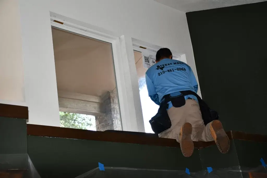 Worker installing a window, ensuring proper fit and seal