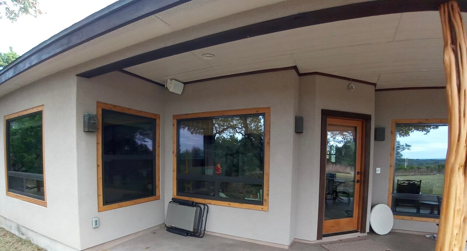 Stylish patio featuring energy-efficient windows and a wooden-framed glass door.