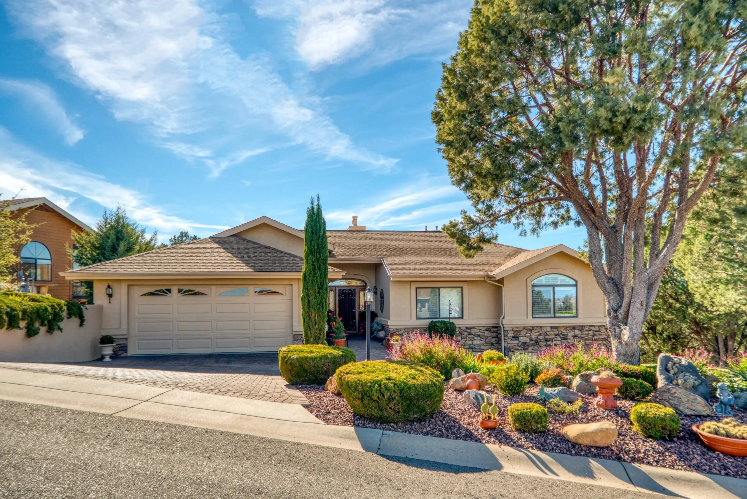 Beautiful stucco home with updated windows and drought-tolerant landscaping in San Antonio, Texas.